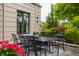A cozy outdoor patio set with wrought iron furniture and manicured landscaping offers an inviting space for relaxation at 1894 Rhettsbury St, Carmel, IN 46032
