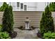 Ornamental water fountain surrounded by manicured evergreens and landscaping creating a serene focal point at 1894 Rhettsbury St, Carmel, IN 46032