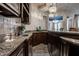 Finished basement with a granite countertop, decorative tile backsplash and views into the main living space at 1894 Rhettsbury St, Carmel, IN 46032