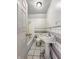 Bathroom with older fixtures and a tub and tiled walls in need of repair at 1947 N Parker Ave, Indianapolis, IN 46218