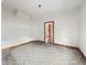 Empty bedroom featuring white walls and trim with neutral carpet, awaiting personalization and renovation at 1947 N Parker Ave, Indianapolis, IN 46218