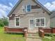 Quaint one-story home featuring vinyl siding, brick accents, and a well-maintained lawn at 1947 N Parker Ave, Indianapolis, IN 46218
