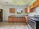 This kitchen has tile floors, wooden cabinets, and natural light, ready to be transformed into your dream cooking space at 1947 N Parker Ave, Indianapolis, IN 46218