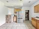 The kitchen has tile floors, wood cabinets, and an updated refrigerator, awaiting renovation to realize its full potential at 1947 N Parker Ave, Indianapolis, IN 46218