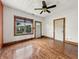 A bright living room features wood floors, a ceiling fan, natural lighting, and white walls for a simple and inviting space at 1947 N Parker Ave, Indianapolis, IN 46218