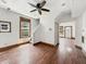Features bright white walls, hardwood floors, a ceiling fan, natural lighting, and access to the staircase at 1947 N Parker Ave, Indianapolis, IN 46218
