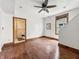 This room offers hardwood floors, bright white walls, natural lighting, and a ceiling fan for comfort and style at 1947 N Parker Ave, Indianapolis, IN 46218