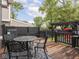 Back deck with lattice chairs, table, wooden pergola, and blue decorative rug at 2222 Pleasant St, Indianapolis, IN 46203