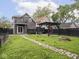 Fenced backyard with stone path, wooden pergola, fire pit, and upper level deck at 2222 Pleasant St, Indianapolis, IN 46203