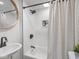 Bathroom with white subway tile shower, unique black and white inset tile, and round mirror at 2222 Pleasant St, Indianapolis, IN 46203