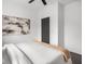 Comfortable bedroom with a soft blanket, abstract art on the wall and a view of the closet at 2222 Pleasant St, Indianapolis, IN 46203