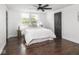 Bright bedroom featuring a window, ceiling fan, and stylish decor at 2222 Pleasant St, Indianapolis, IN 46203