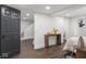 Bedroom featuring warm wood-look tile flooring, a console table, and a view into an adjacent room at 2222 Pleasant St, Indianapolis, IN 46203