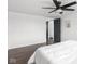 Bedroom with a ceiling fan, window, and doorway to a laundry area at 2222 Pleasant St, Indianapolis, IN 46203
