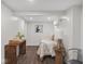 Cozy bedroom featuring clean white walls, stylish decor, and warm wood-look tile flooring at 2222 Pleasant St, Indianapolis, IN 46203