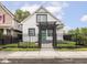 Charming home with black iron gate, black trim, and front yard landscaping at 2222 Pleasant St, Indianapolis, IN 46203