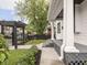View of a charming pergola, black metal fence and manicured landscaping adjacent to the front porch at 2222 Pleasant St, Indianapolis, IN 46203