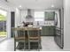 Eat-in kitchen featuring an island, stainless appliances and a tile backsplash at 2222 Pleasant St, Indianapolis, IN 46203