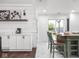 Modern kitchen with white tile walls, stainless appliances, and a breakfast bar island at 2222 Pleasant St, Indianapolis, IN 46203