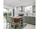 Eat-in kitchen featuring an island, modern appliances and fixtures with a view to the backyard at 2222 Pleasant St, Indianapolis, IN 46203