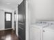 Convenient laundry area with modern appliances and stylish barn door at 2222 Pleasant St, Indianapolis, IN 46203