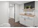 Bright laundry room featuring white cabinets, wooden countertop, decor tiles, and modern shelving at 2222 Pleasant St, Indianapolis, IN 46203