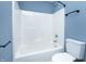 Bathroom featuring a white shower-tub combo, toilet, and modern gray flooring at 2402 Adams St, Indianapolis, IN 46218