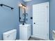 Modern bathroom with white vanity, contemporary black fixtures and calming blue walls at 2402 Adams St, Indianapolis, IN 46218