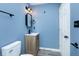 Remodeled bathroom with updated vanity, mirror, modern fixtures, and modern gray flooring at 2402 Adams St, Indianapolis, IN 46218