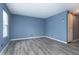 Spacious bedroom with gray floors, window and sliding barn door at 2402 Adams St, Indianapolis, IN 46218