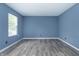 Bedroom featuring gray wood flooring, neutral walls and window at 2402 Adams St, Indianapolis, IN 46218
