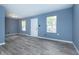 Bright living room with modern gray flooring, fresh paint, and ample natural light at 2402 Adams St, Indianapolis, IN 46218