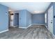 Open concept living room with gray flooring, connecting laundry room, and bright paint at 2402 Adams St, Indianapolis, IN 46218