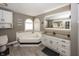 Elegant bathroom showcasing a luxurious soaking tub, sleek vanity, and well-lit mirror for a spa-like experience at 28 Patriot Ct, Greenfield, IN 46140