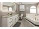 Bright bathroom with a soaking tub, stylish vanity, and ample lighting, providing a comfortable and modern space at 28 Patriot Ct, Greenfield, IN 46140