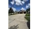 Charming brick home with a spacious driveway, two car garage, well-manicured lawn, and flagpole under a bright, partly cloudy sky at 28 Patriot Ct, Greenfield, IN 46140