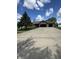 Brick home with a large driveway and an attached two-car garage, framed by a green lawn and mature trees under a blue sky at 28 Patriot Ct, Greenfield, IN 46140