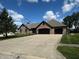 Beautiful brick home with well-manicured lawn, three-car garage, and ample parking space in the driveway at 28 Patriot Ct, Greenfield, IN 46140