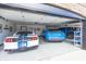 Well-maintained garage with epoxy flooring, and multiple vehicles at 28 Patriot Ct, Greenfield, IN 46140