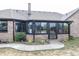 Enclosed sunroom featuring large windows and access to the yard, built with brick facade at 28 Patriot Ct, Greenfield, IN 46140