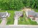 Aerial view of a charming home with mature landscaping, a driveway, and a traditional roof at 2875 Prairie Stream Way, Columbus, IN 47203