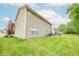 Backyard view displaying ample lawn space adjacent to a two-story residence with vinyl siding at 2875 Prairie Stream Way, Columbus, IN 47203