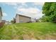 Expansive backyard featuring a well-maintained lawn with an exterior view of a two-story home at 2875 Prairie Stream Way, Columbus, IN 47203