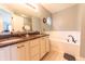 Bright bathroom features a double vanity with granite countertop and a soaking tub at 2875 Prairie Stream Way, Columbus, IN 47203