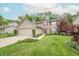 Charming two-story home with a two-car garage, brick accents, and a beautifully landscaped front yard at 2875 Prairie Stream Way, Columbus, IN 47203