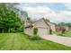 Charming home exterior featuring a two-car garage and well-manicured lawn at 2875 Prairie Stream Way, Columbus, IN 47203
