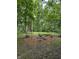 Inviting fire pit area nestled among mature trees and log seating, perfect for outdoor gatherings at 2875 Prairie Stream Way, Columbus, IN 47203
