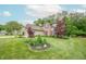Well-manicured front yard with decorative landscaping complements this two-story home's exterior at 2875 Prairie Stream Way, Columbus, IN 47203