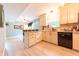 Bright kitchen area with stainless steel appliances, wooden floors, and granite countertops at 2875 Prairie Stream Way, Columbus, IN 47203