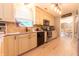 Well-lit kitchen featuring stainless steel appliances, updated cabinets, and granite countertops at 2875 Prairie Stream Way, Columbus, IN 47203